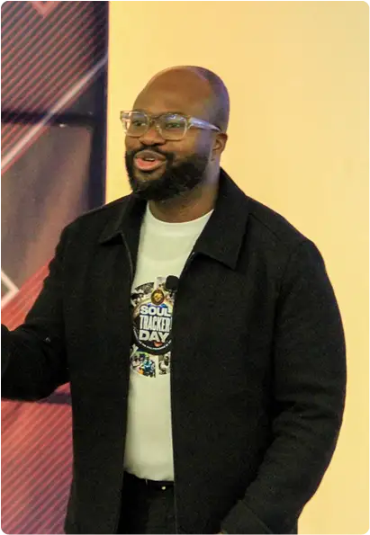 Picture of a man on his knees on the floor praying in a crowd of people
